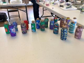 Polymer clay decorated bottles to be donated to Bottles of Hope